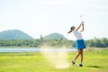 Golfer sport course golf ball fairway. People lifestyle woman playing game golf and hitting out of sand trap go on green grass Royalty Free Stock Photo